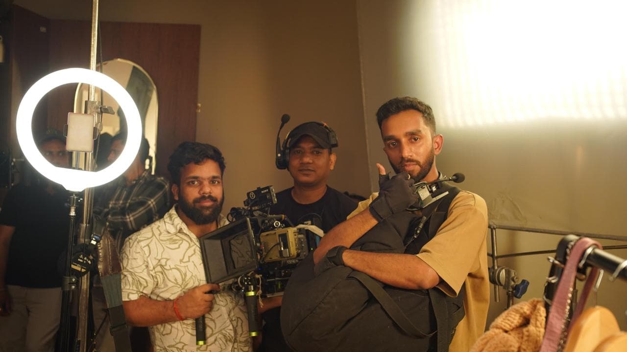 Production crew on set with cameras and a ring light